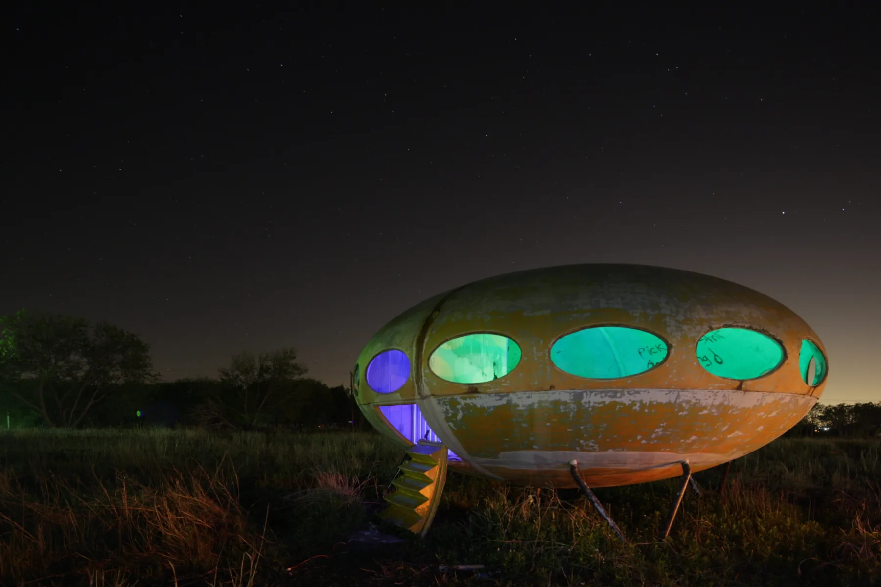The same Futuro house as shot, before any adjustment: flatter, browner and brighter, with a hazy grey-green sky.