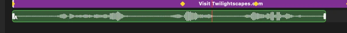 Close-up of an audio track on the timeline: a green bar filled with a real mirrored-peak waveform drawn from the source file, the red playhead crossing it, with the purple caption bar and its yellow keyframe diamonds directly above.